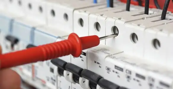 Electrical contractor testing circuit breakers during electrical repair in Lancaster, NY