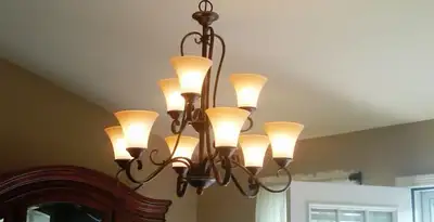 Classic ceiling chandelier installation with warm lighting in Buffalo, NY
