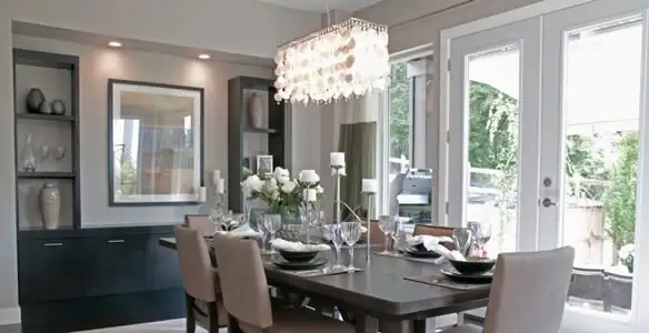 Elegant dining room chandelier installation above table in Buffalo, NY