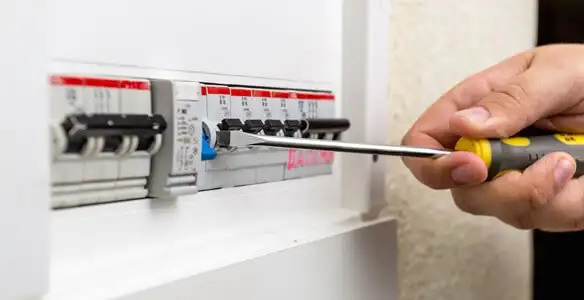 electrical panel upgrade service showing technician adjusting circuit breakers during system upgrade in Buffalo, NY