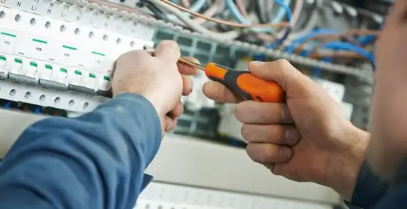 electrical service showing licensed electrician performing electrical panel maintenance and adjustments in Buffalo, NY