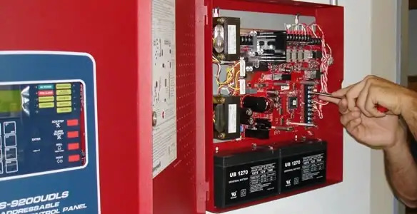 fire alarm installation service showing technician configuring fire alarm control panel in Buffalo, NY