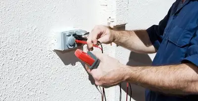 Electrician performing home electrical outlet and wiring inspection in Buffalo, NY