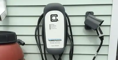 Outdoor electric vehicle charger installation on residential wall in Buffalo, NY