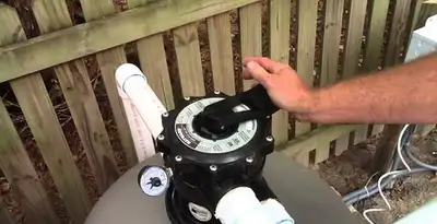 pool pumps service showing professional adjustment of pool pump control system in Buffalo, NY