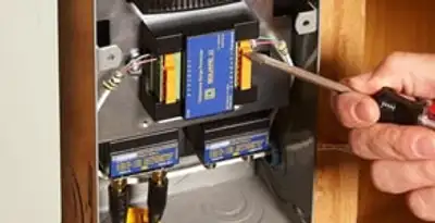 Whole home surge protection device being installed by a licensed electrician to protect electrical systems in Buffalo, NY